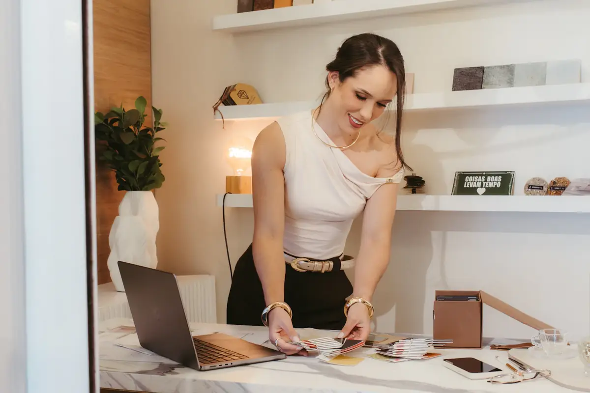 An online seller packing an order beside her laptop