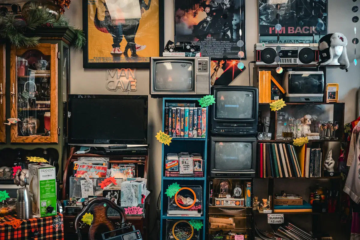 A second-hand shop wall of old televisions, radios and records