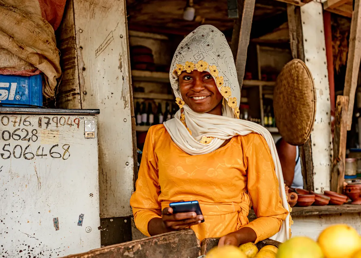 A stallholder smiling at her phone