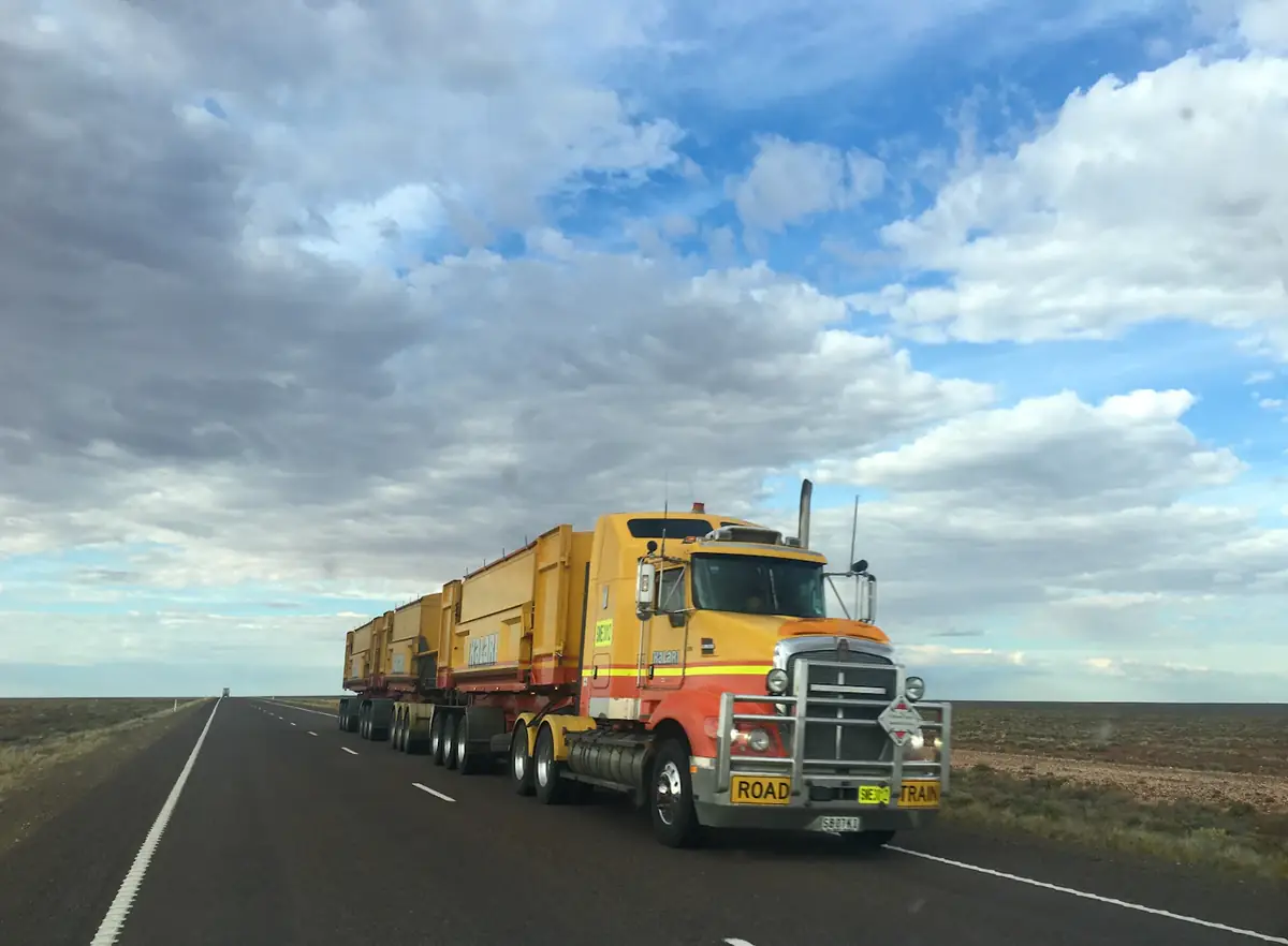 A road train on an open highway under a big sky