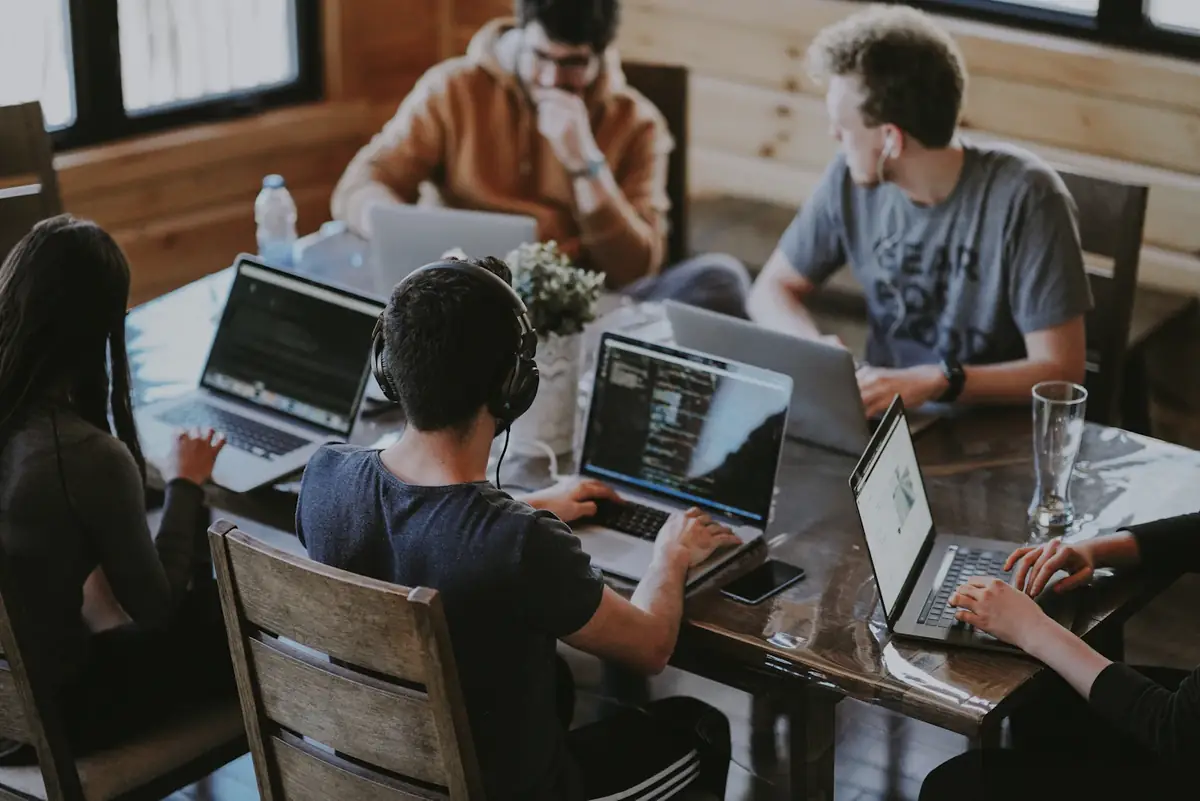 Engineers writing code at a long shared table