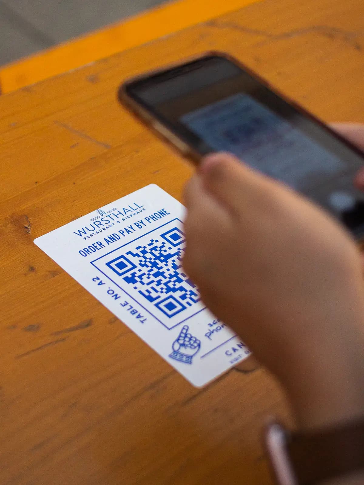 A phone scanning a table's order-and-pay QR code