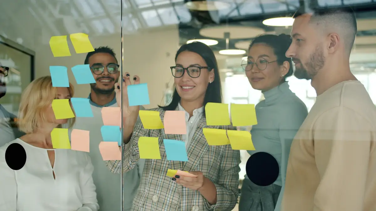 A team planning with sticky notes on a glass wall