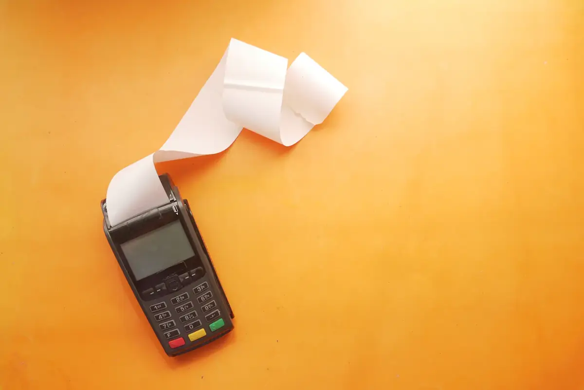 A card machine printing a receipt